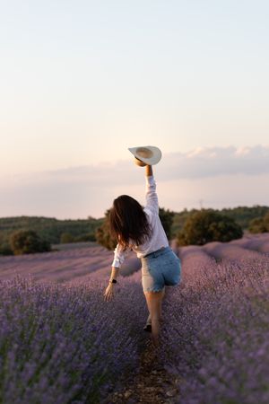 Anonymous woman walking in lavender field