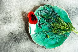 Green ceramic plate with poppy flower