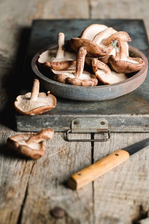 Pile of fresh brown mushrooms on rustic wooden table