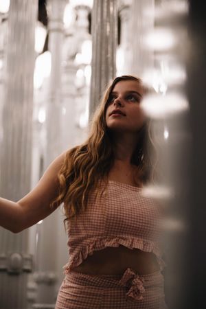 Woman in plaid outfit looking up