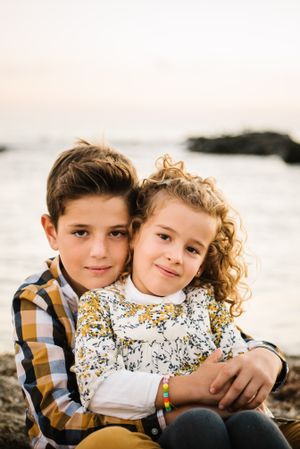Cute boy and girl hugging each other at beach