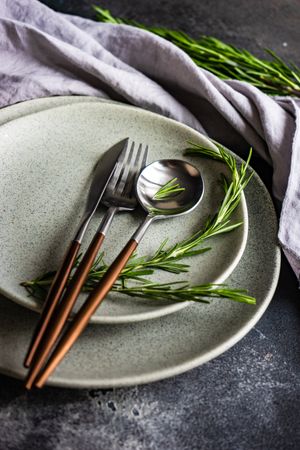 Grey plate set with fresh rosemary