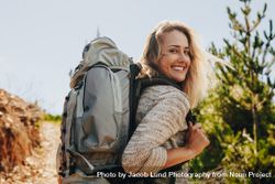 Woman with backpack hiking in nature 4AzVPq