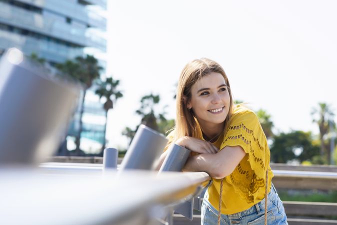 Young woman leaning handrail