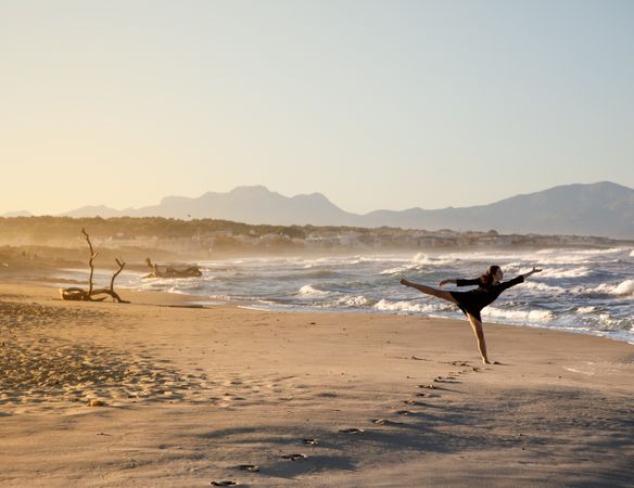 Woman with dancing near water on shore