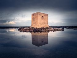 Wonderful watchtower in calm lake on cloudy day