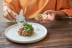 Unrecognizable female eating steak tartare