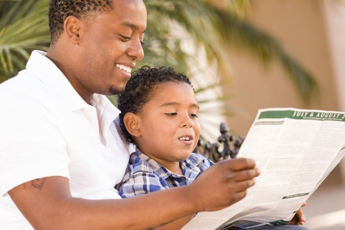 Father and Son Reading Park Brochure Outside