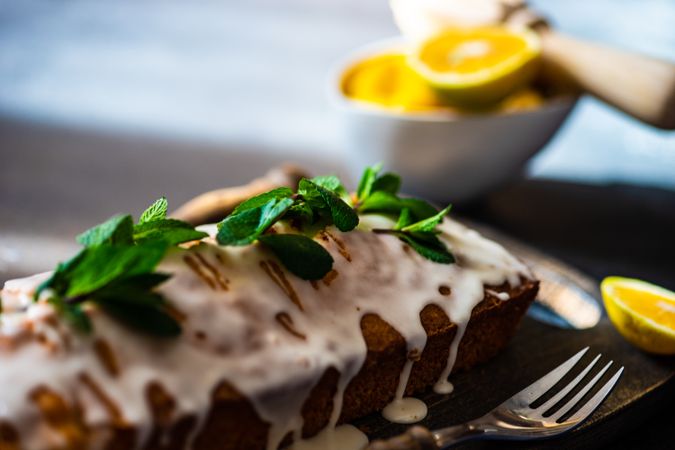 Mint garnish of freshly baked lemon cake dessert with icing