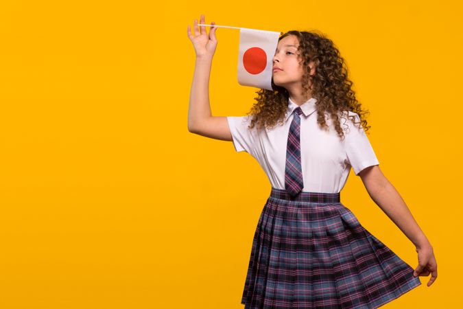 Girl playfully waving Japanese flag
