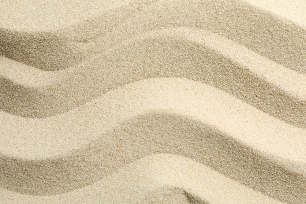 Seamless sand on a whole background, space for text. Summer vacation backdrop
