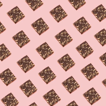 Chocolate square cookie pattern on a soft pink background