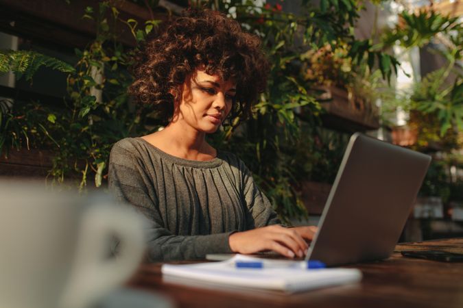 Woman working on laptop outdoors