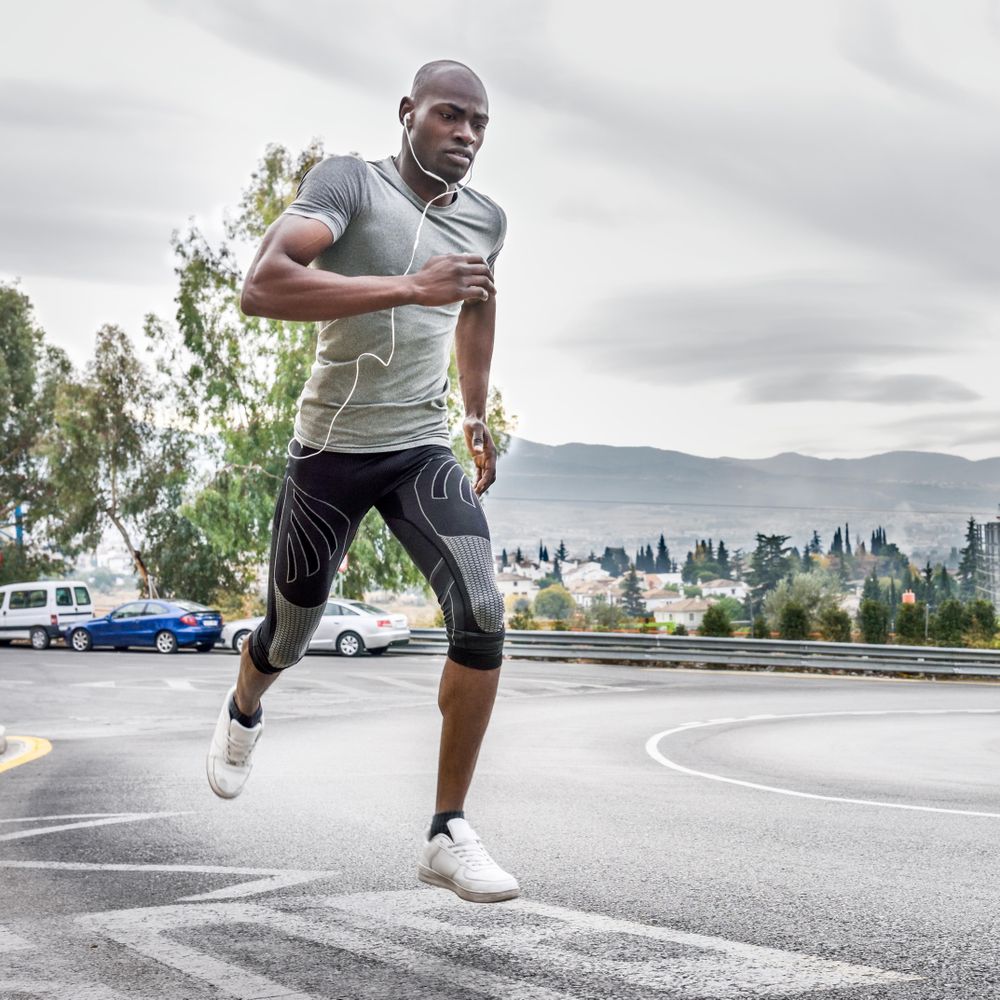 Healthy male running on city street