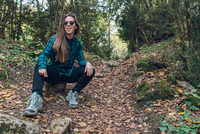 Stylish female teenager in casual outfit at autumn forest