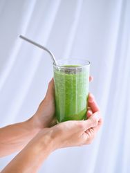 Unrecognizable person with glass of smoothie