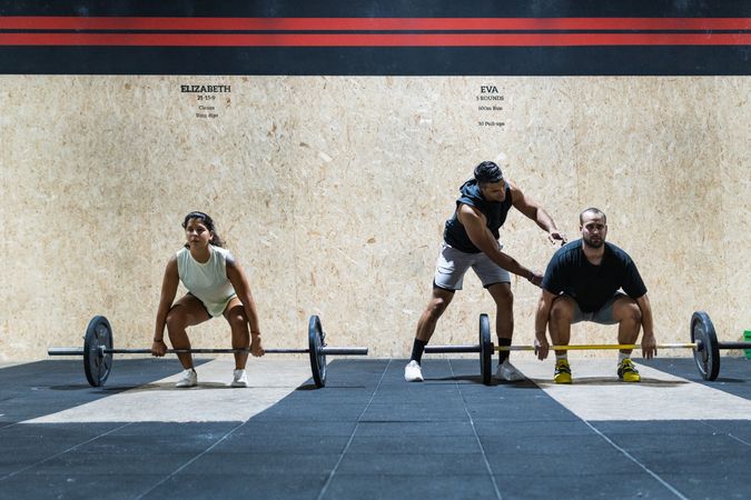Hispanic sportspeople training with barbells
