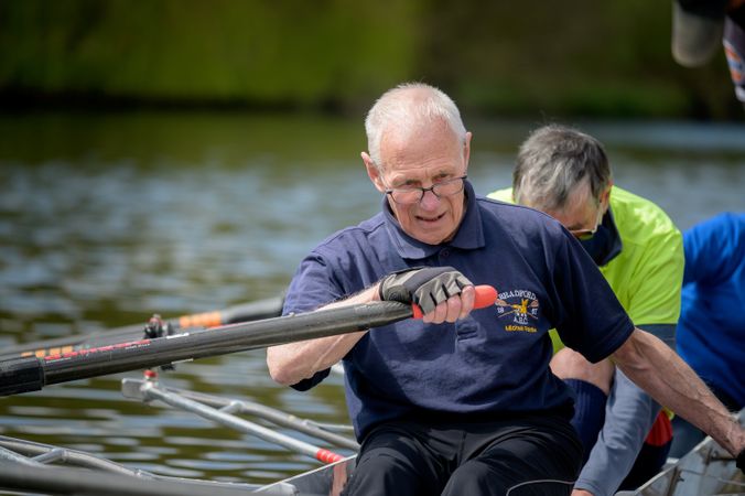 Grey haired man rowing