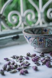 Dried flower buds and bowl near window