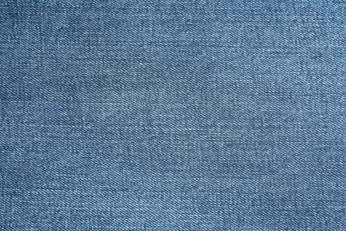Texture of blue jeans as background, space for text