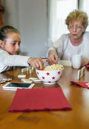 Grandmother and granddaughter playing domino
