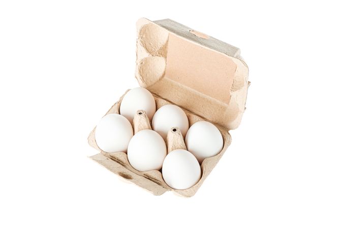 chicken eggs in carton box isolated on blank background