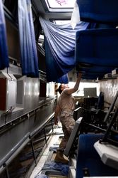 Military woman looking up inside vehicle