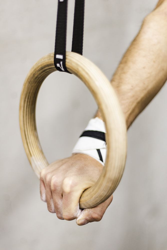 Man training with gymnastic rings in gym