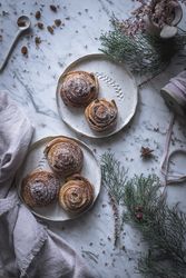 Herbs and napkin near cinnamon rolls