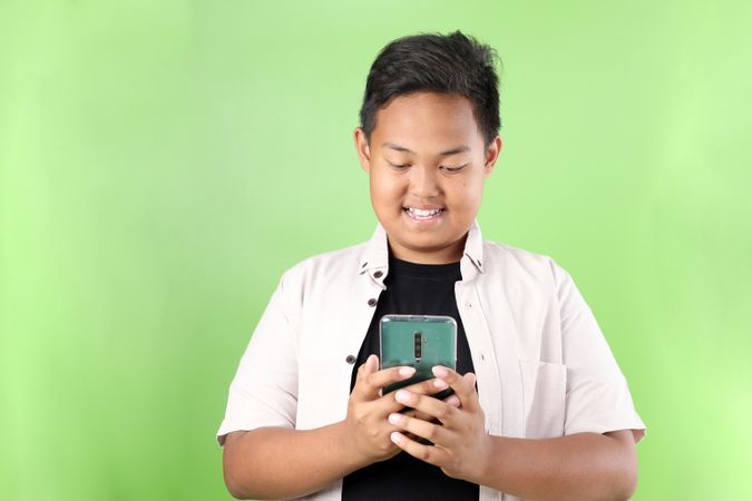 Asian Boy Holding Smartphone