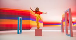 Portrait of Talented Black Female Artist Showcasing Dance Movements in Abstract Colorful Studio Decoration.