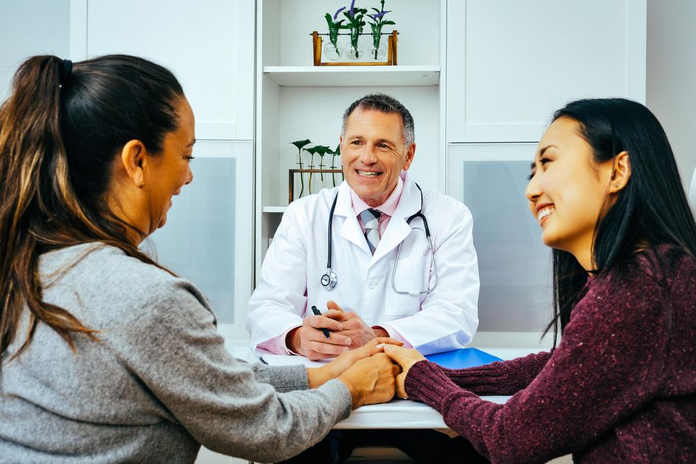 Two patients receiving good news in doctor’s office