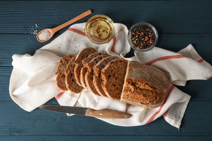 Composition with freshly baked bread on wooden background, top view and space for text