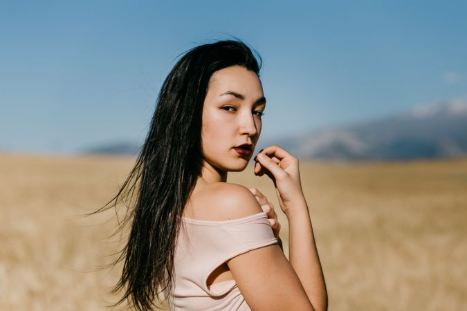 Female model standing in field
