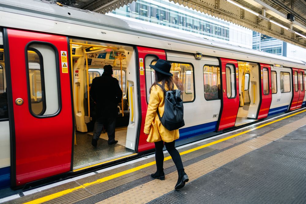 Cheerful woman catching train on station