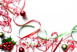 Christmas theme backdrop with red and green ornaments, ribbons, candy cane, and confetti.