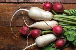 Red radish and daikon on wooden table