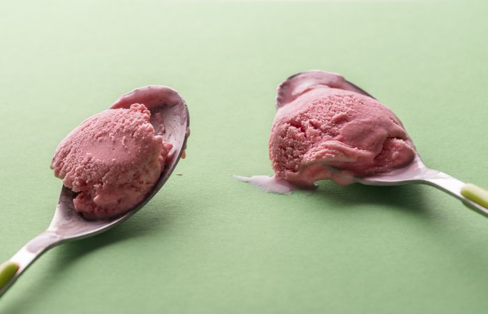 Rose ice cream in spoons close-up