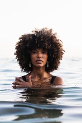 Black woman in bikini in sea