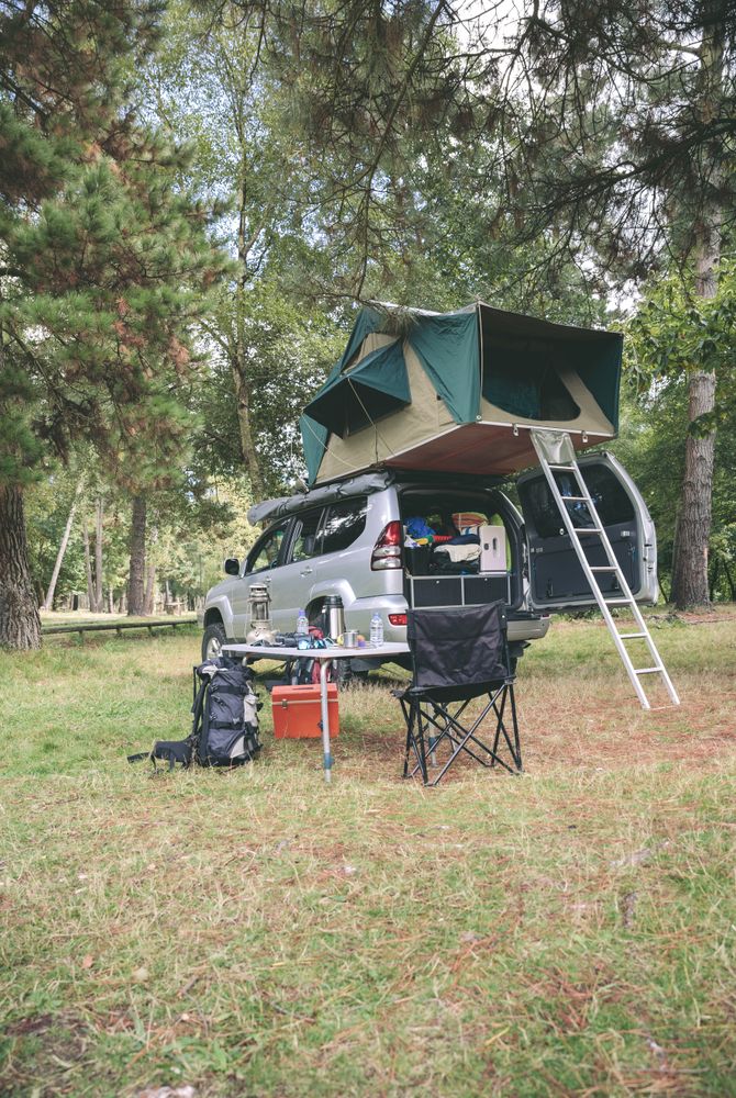 Offroad 4x4 vehicle with tent on roof for camping
