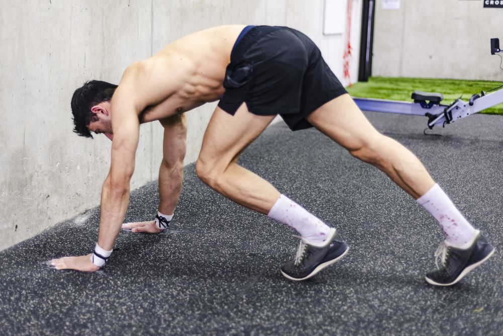 Man doing handstand in gym