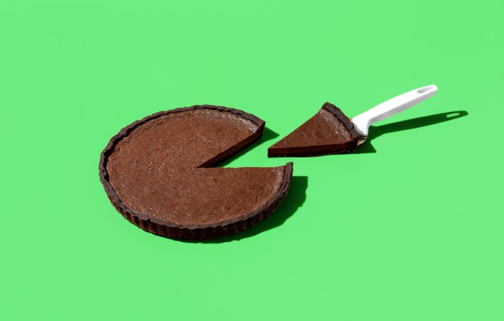 Chocolate tart isolated on a vibrant green background
