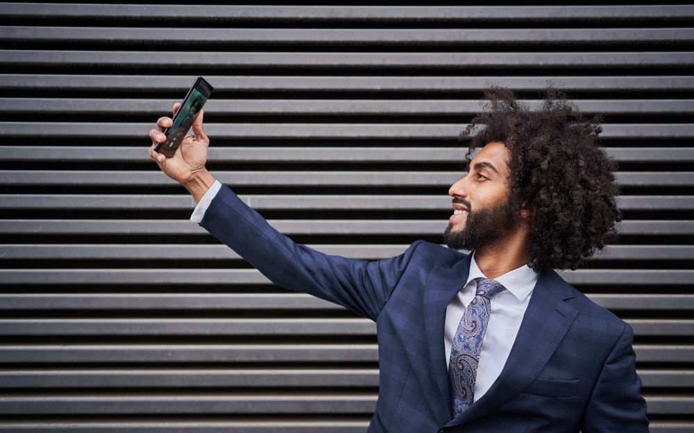 Joyful man taking selfie and smiling