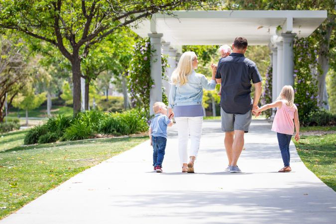 Young Family Taking A Walk In The Park