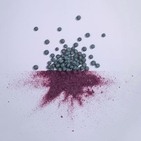 Blueberries with purple dust on purple background