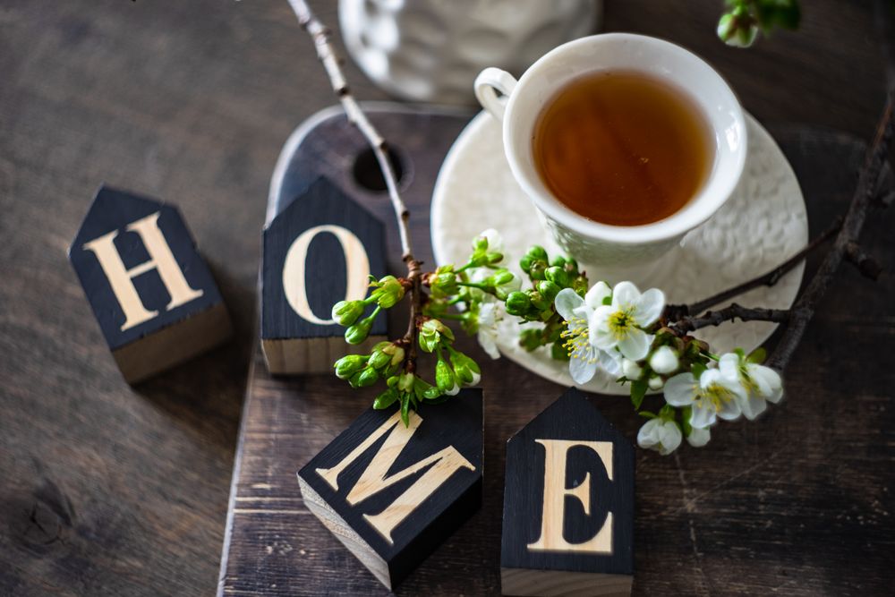 Tea in cup and saucer with home decor