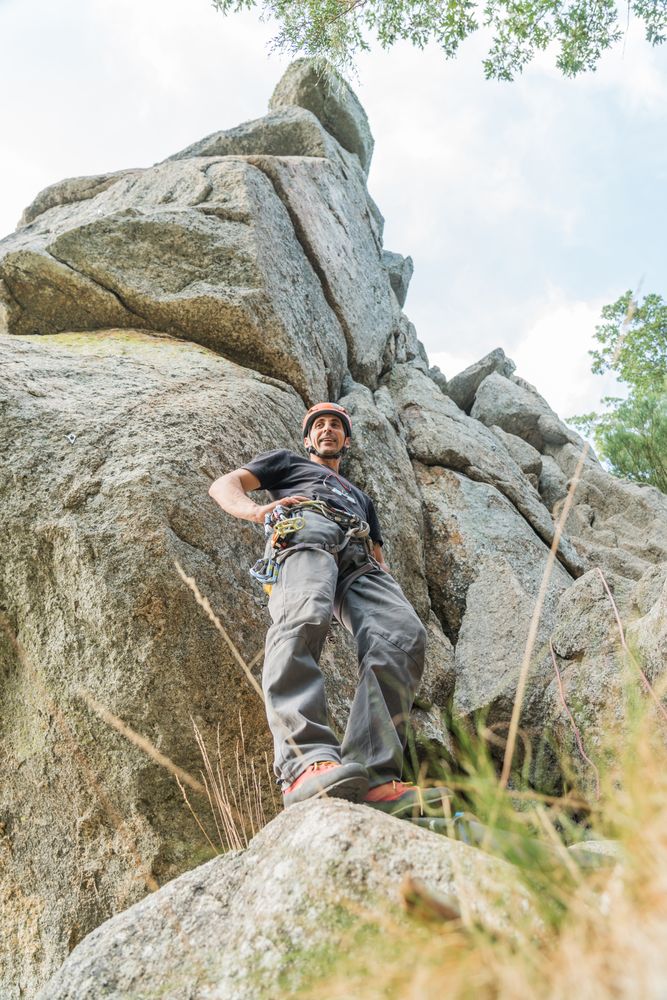 A climber is preparing his ropes to start climbing