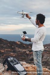 Man holding drone and remote 5zNVQ5