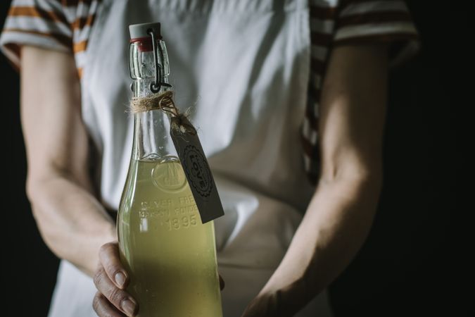 Female with bottle of elderflower syrup