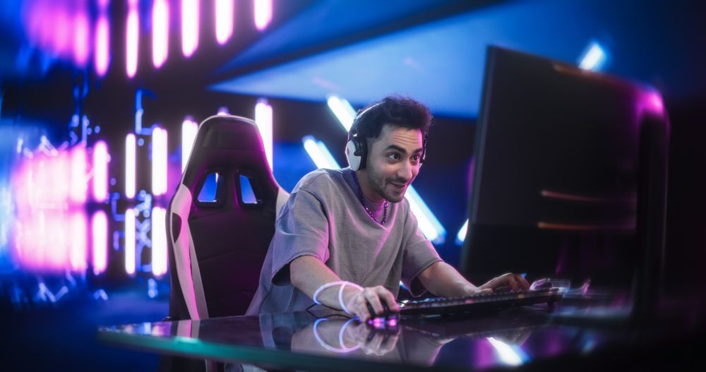 Excited Male Playing Video Games Online on a Computer.